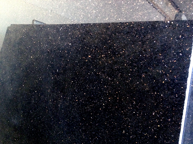 A close up photo of Black Galaxy Granite